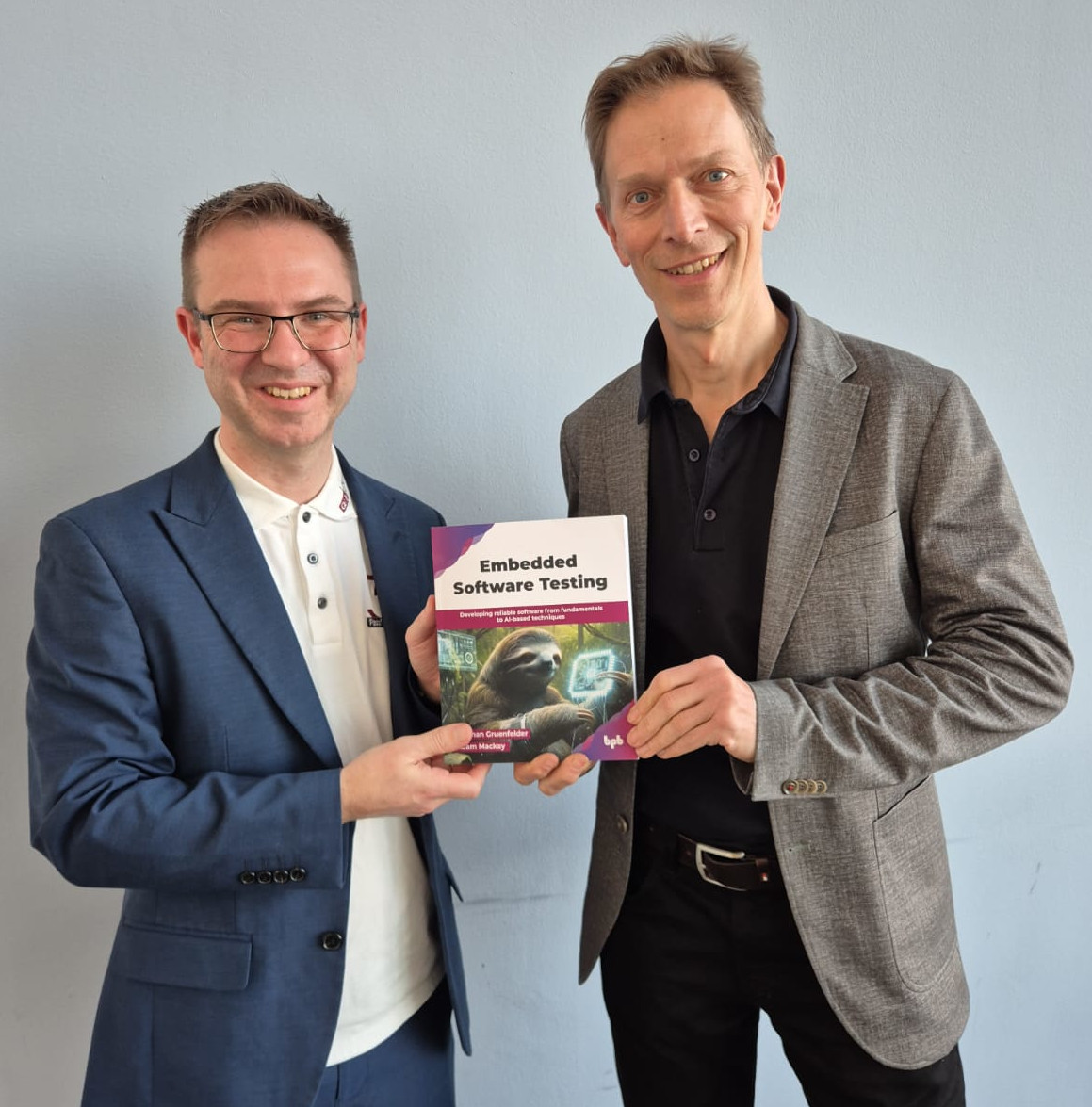 Adam Mackay and Stephan Grünfelder holding the book